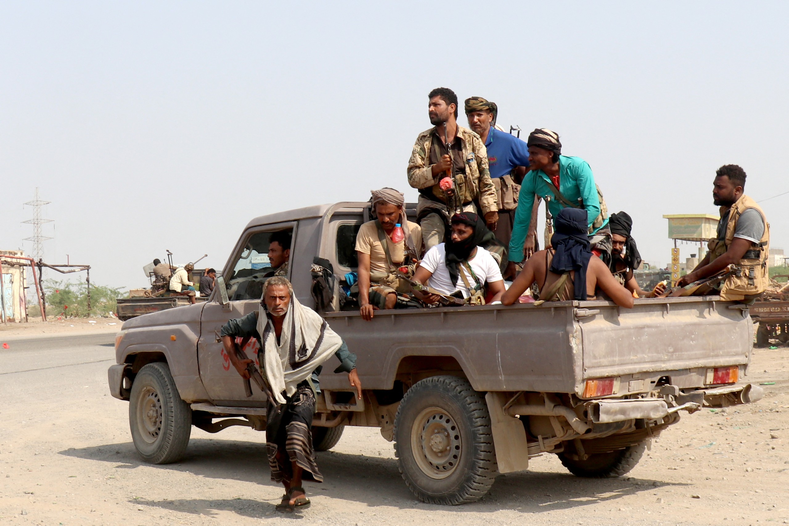 Forces loyal Yemen's Saudi-backed government ride in a pick-up truck in the Hays district, south of Hodeidah.