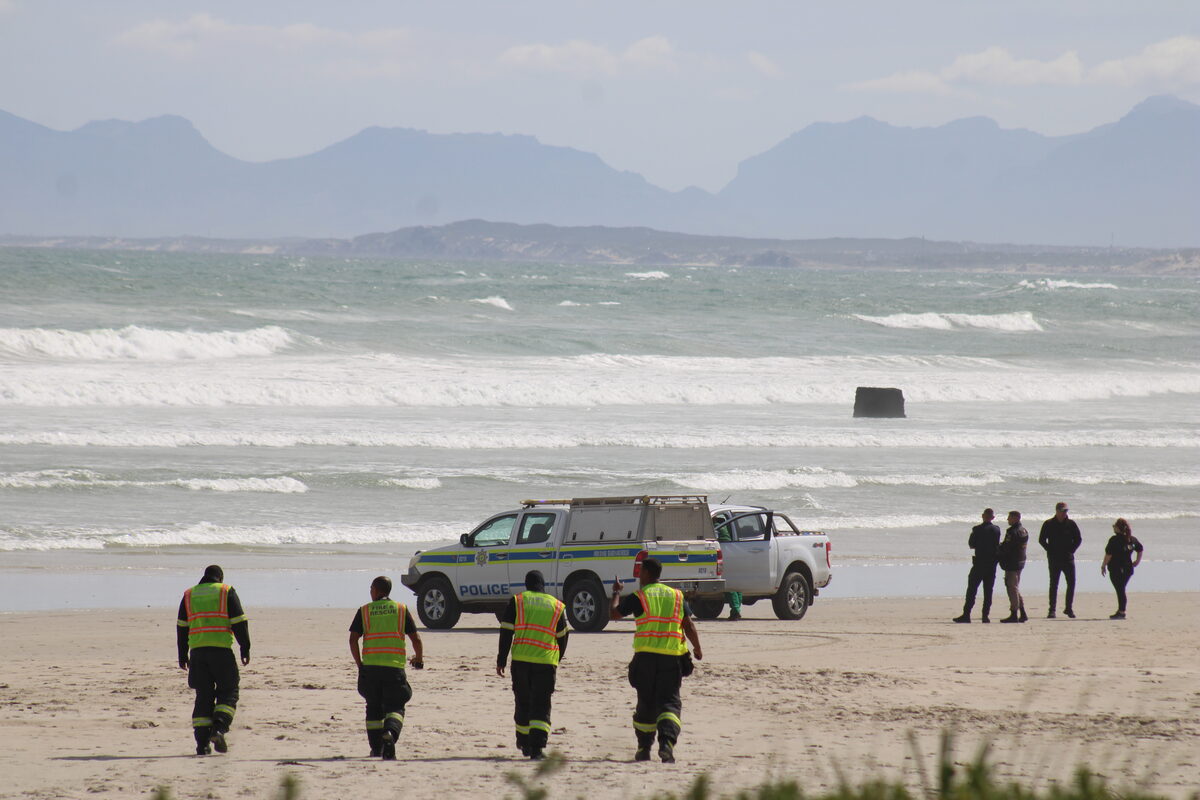Desperate search continues for two men swept away at Strand Beach