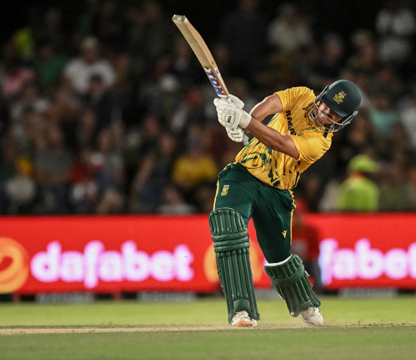 South Africa's Lhuan-dre Pretorius watches the ball after playing a shot during the first Twenty20 international cricket match between South Africa and West Indies