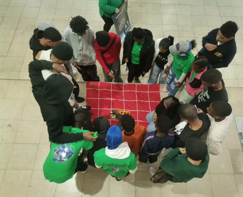 Learners participating in a Coding 4 Africa activity using Tangible coding games in a classroom.