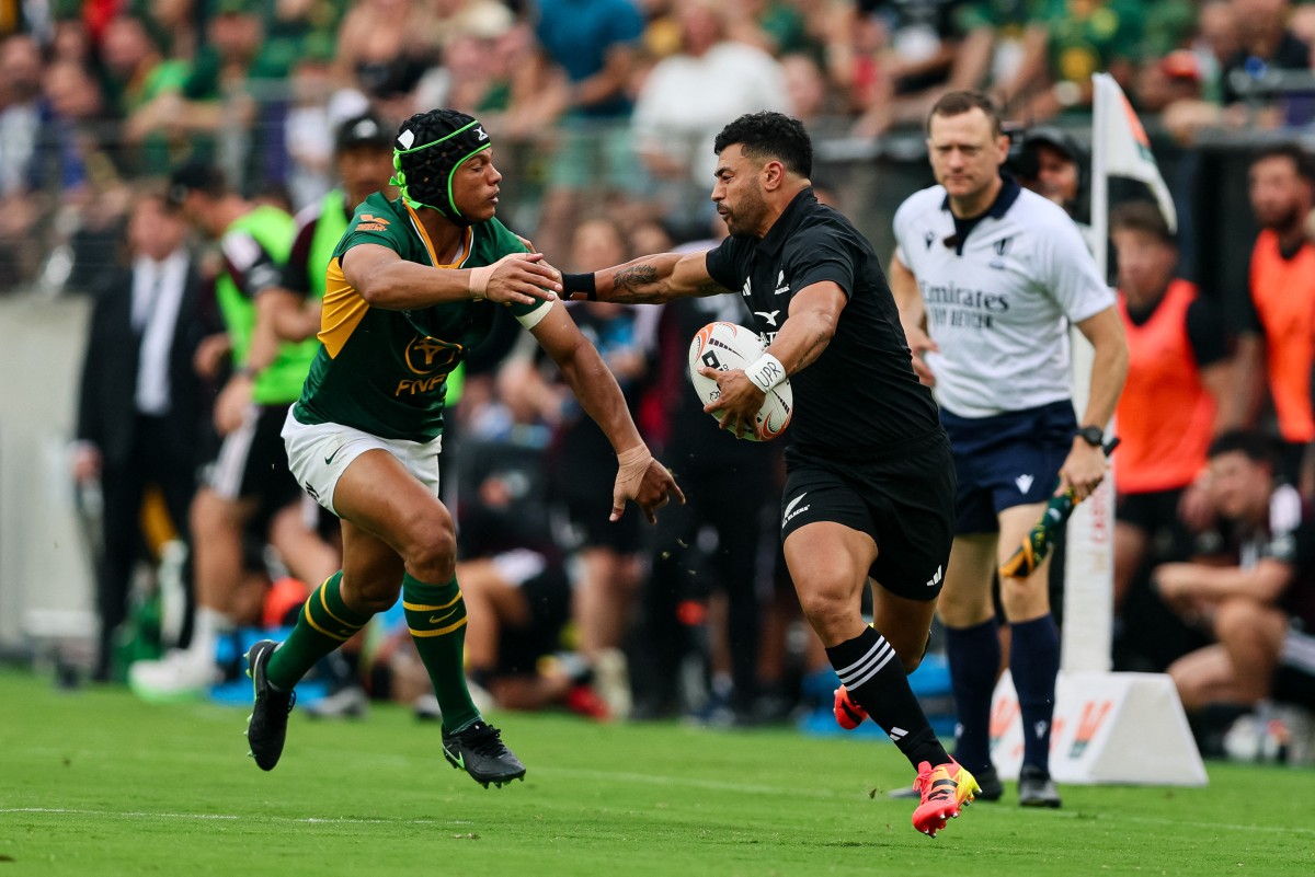 Richie Mo'unga of New Zealand fends off Kurt-Lee Arendse of South Africa during the greatest rivalry test in Baltimore.