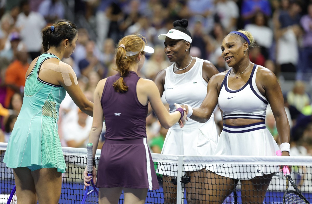 USA's Serena Williams (R) and her sister Venus Williams (2R) shake hands with Australia's Maya Joint (2L) and Taiwan's Chan Hao-ching (L) after losing their women's doubles first-round tennis match