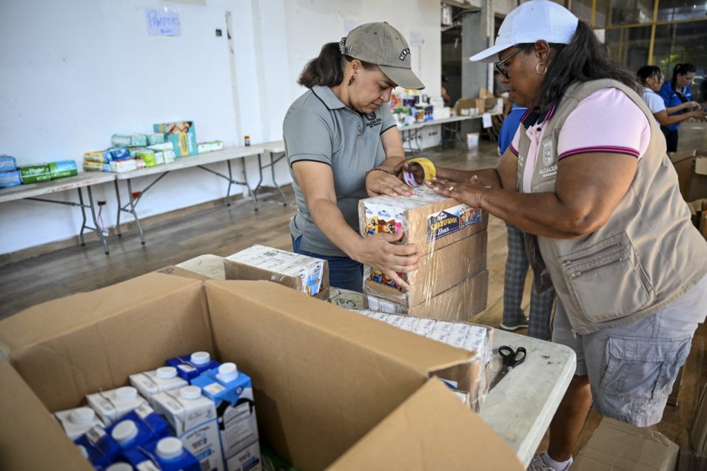 Workers from the Panama City municipality prepare food aid boxes for delivery to areas affected by the earthquake. 