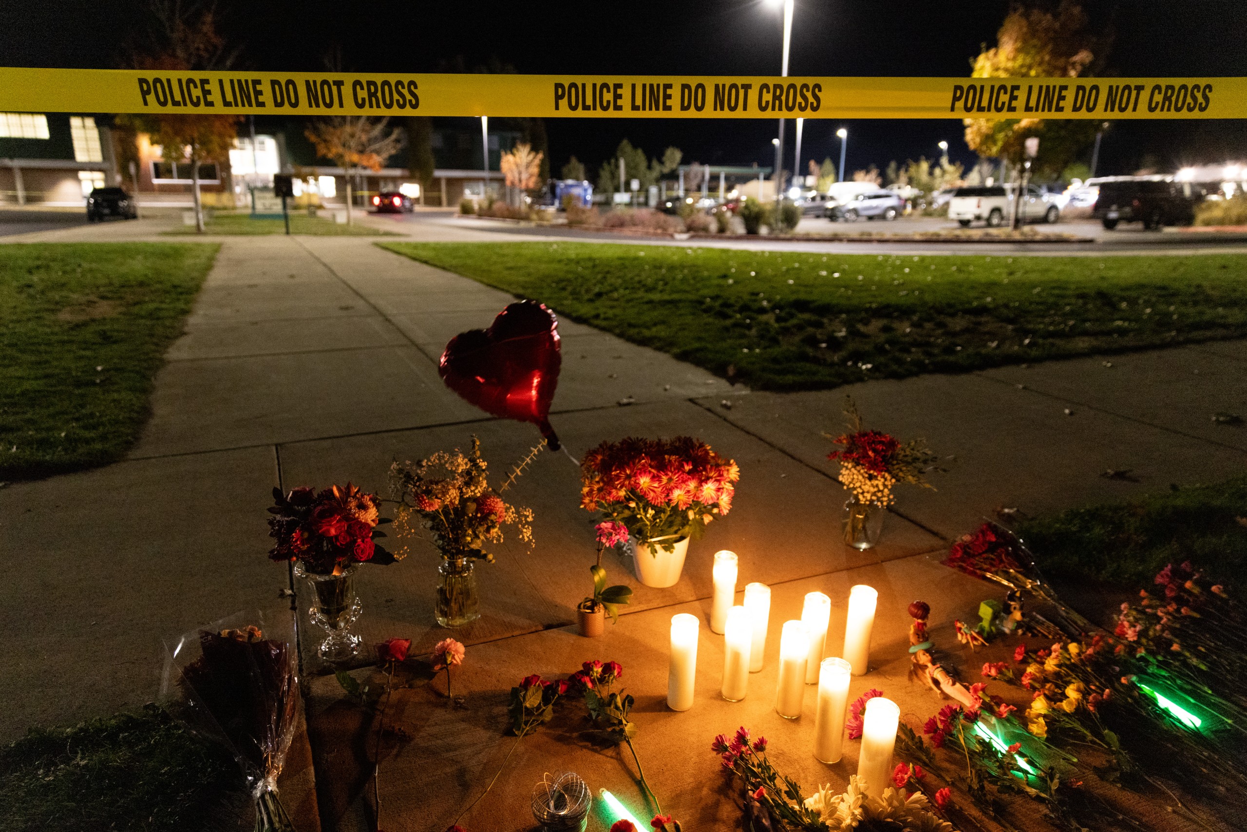 Candles and flowers are seen at a makeshift memorial outside the Silver Rail Elementary School following a shooting in Bend, Oregon, on October 15, 2026. Three children and one teacher were shot dead at an elementary school Thursday in the northwestern US state of Oregon, police said, adding that the assailant was a 16-year-old who was killed by an armed bystander.