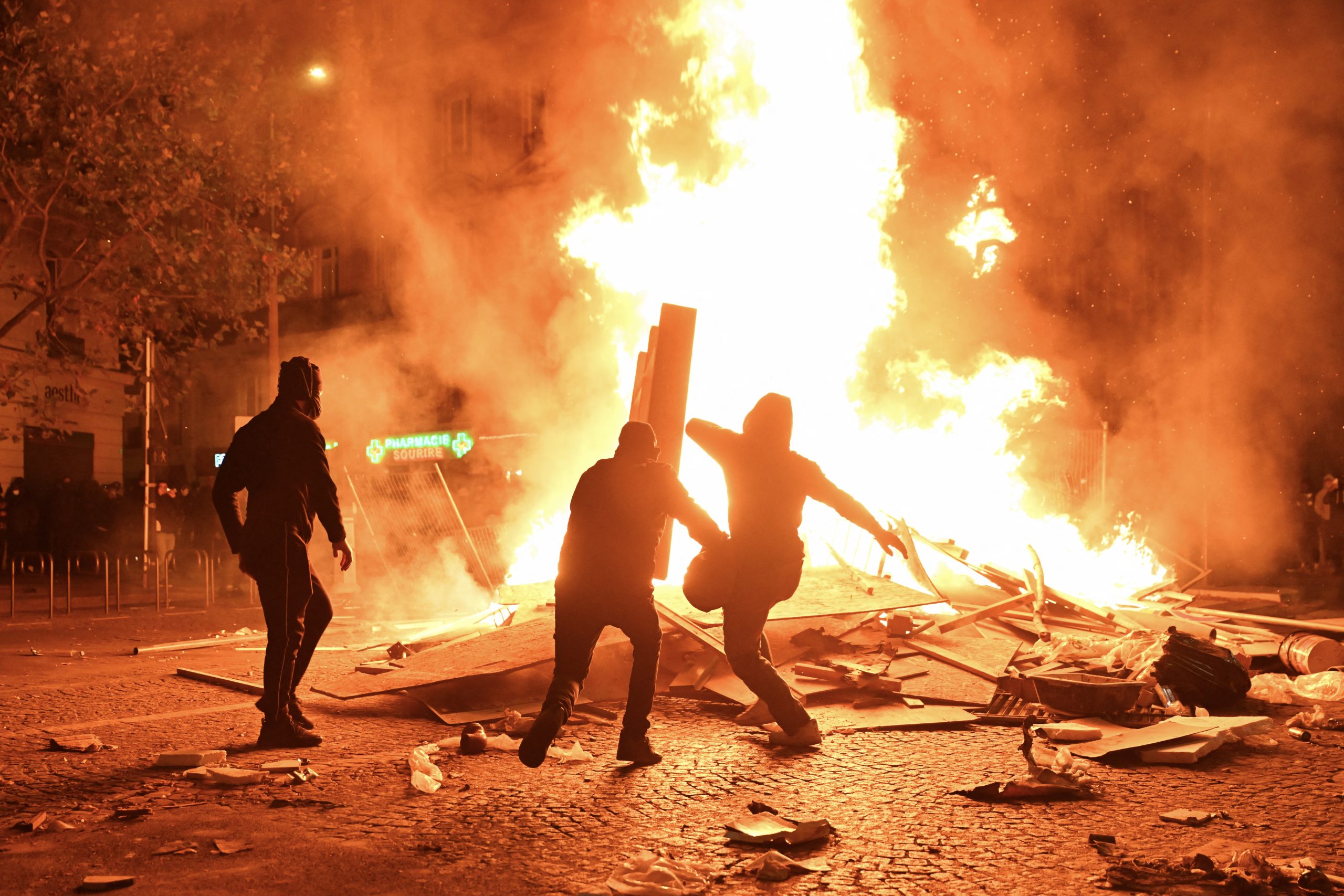 France protests, people burning rubble in the streets of Paris.