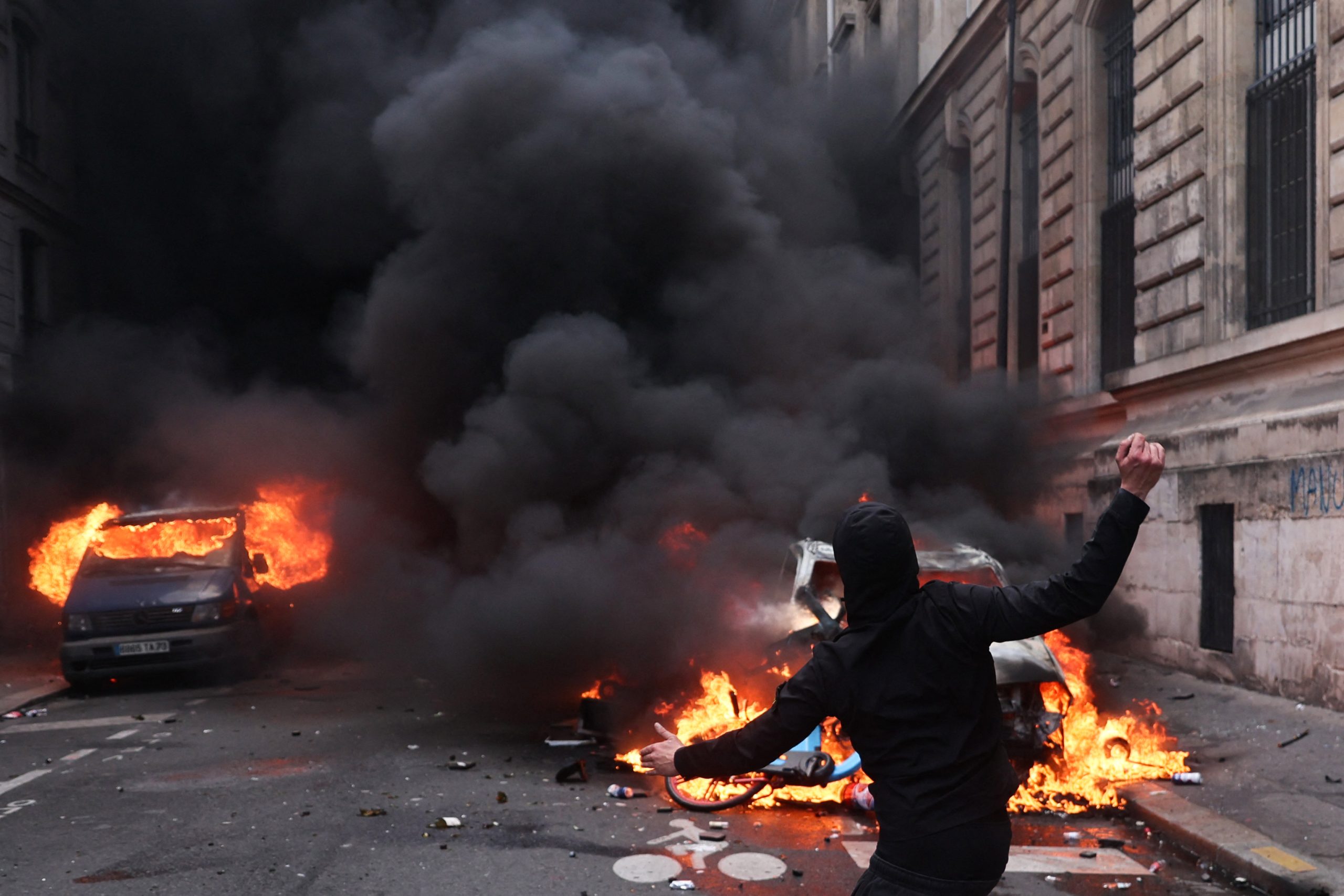 A protester launches a proyectile during a demonstration to protest against the "high cost of living", at Place de la Republique in Paris on October 17, 2026 as part of a nationwide call for mobilisation bringing together various groups expressing their anger: former "Yellow Vest", secondary school and university students, climate activists and even farmers. After weeks of student protests, France faces broader, nationwide demonstrations on October 17, 2026 over the cost of living, setting up a potentially fraught six months heading into a presidential election. A police source told AFP that authorities estimated nearly 200,000 people could take part, with 40,000 in Paris. Photo: Kiran Ridley | AFP