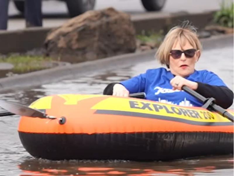 Helen Zille rowing in an inflatable boat.