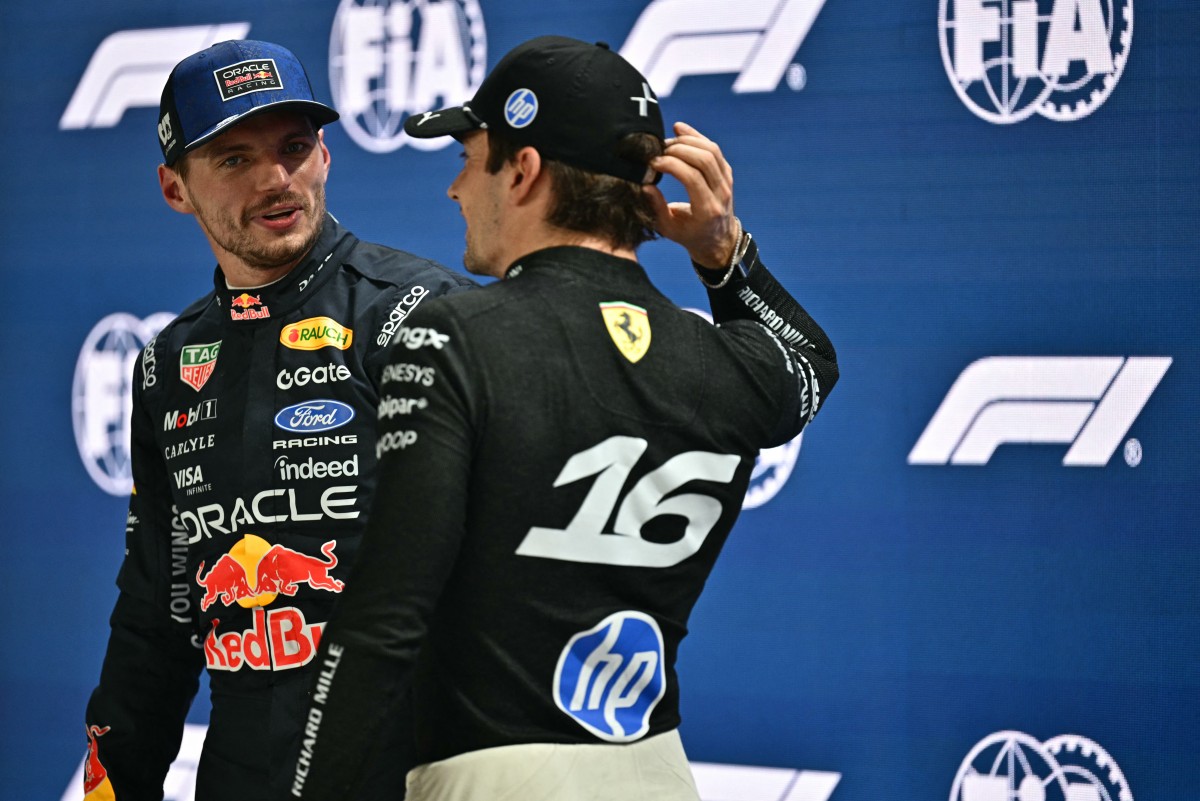 Red Bull Racing's Dutch driver Max Verstappen (L) speaks with Ferrari's Monegasque driver Charles Leclerc after winning the pole position at the end of the qualifying session ahead of the Formula One Singapore Grand Prix at the Marina Bay Street Circuit in Singapore on October 10, 2026.
