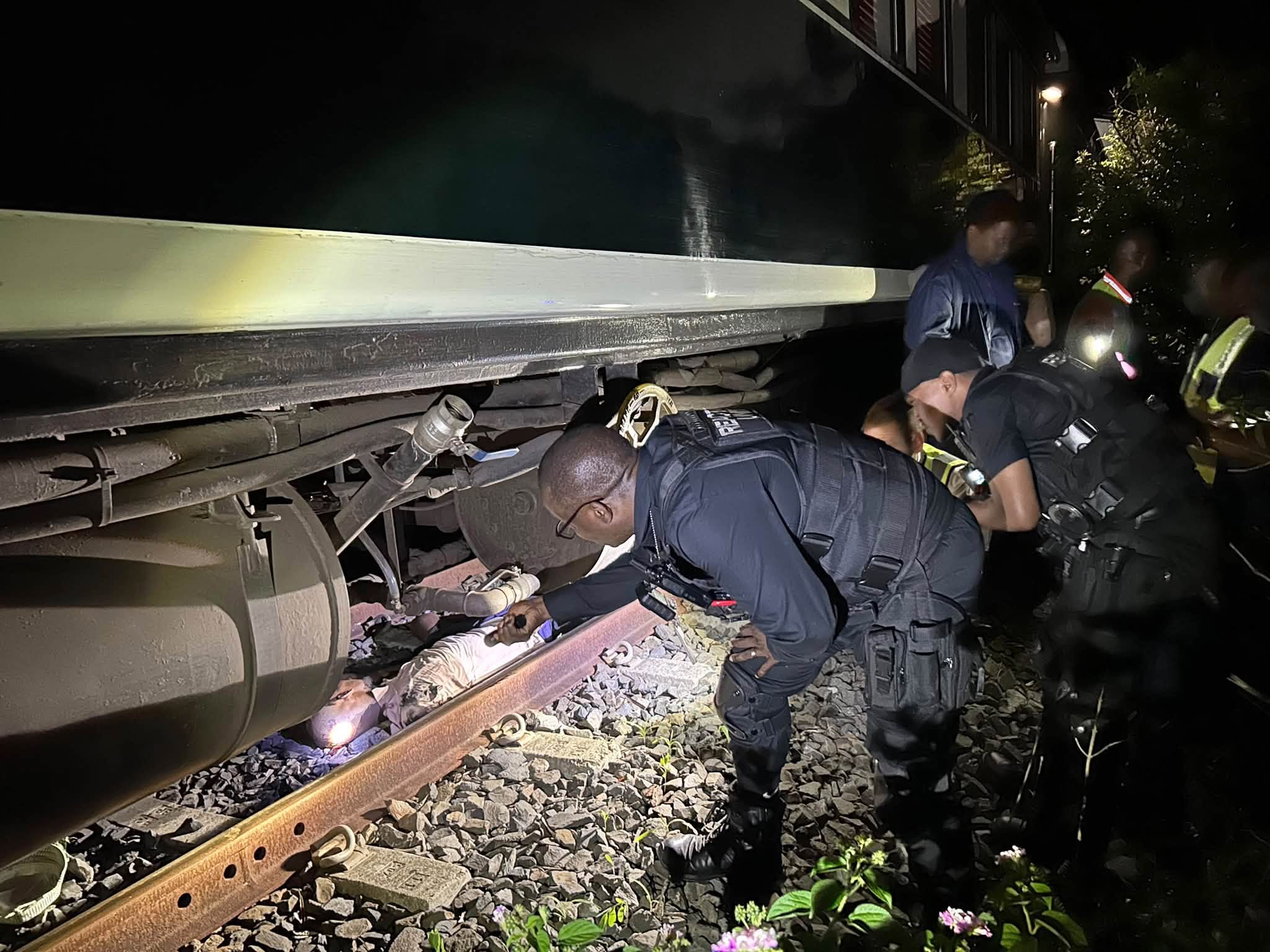 Man trapped beneath train