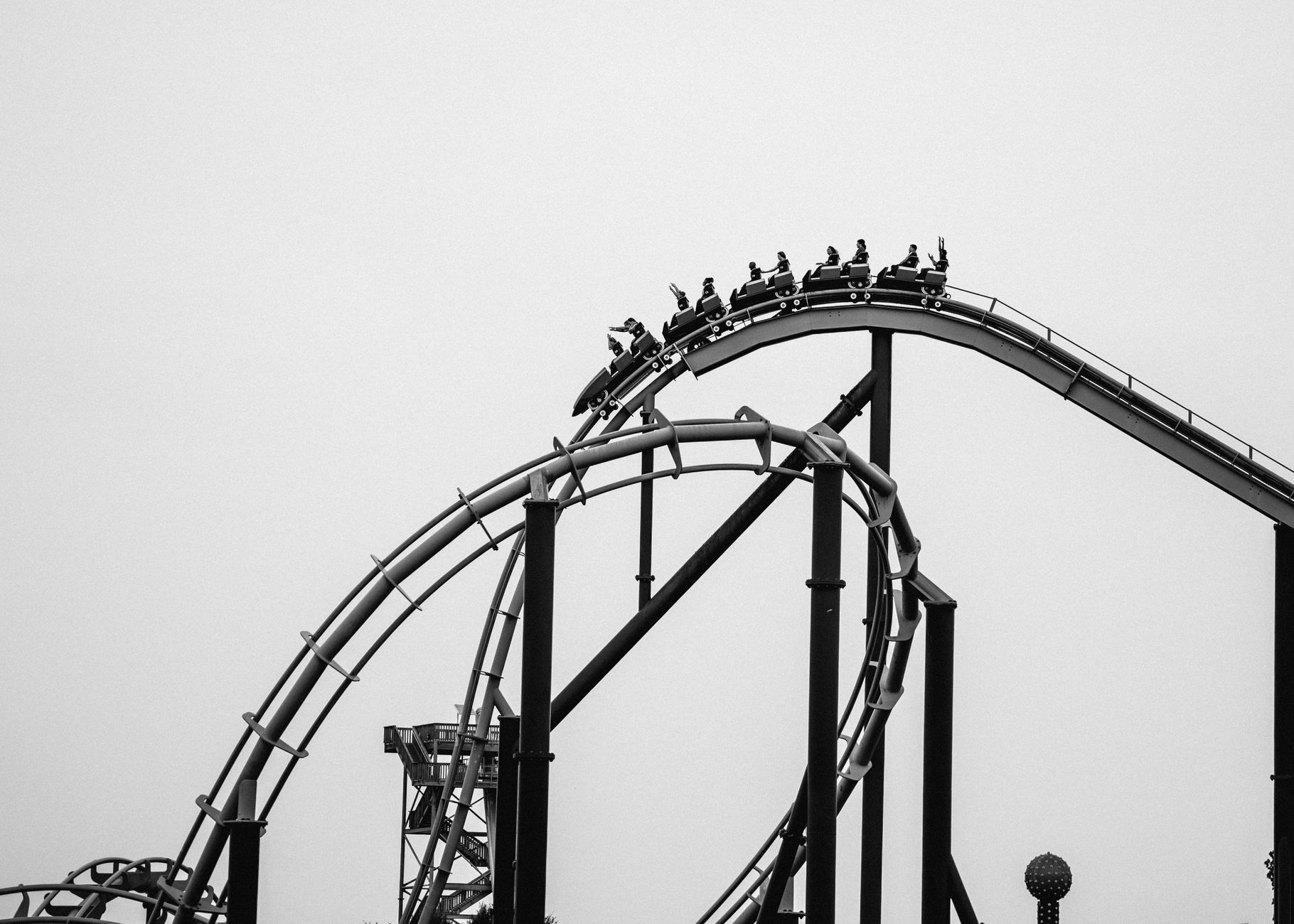 people riding on a roller coaster in an amusement park