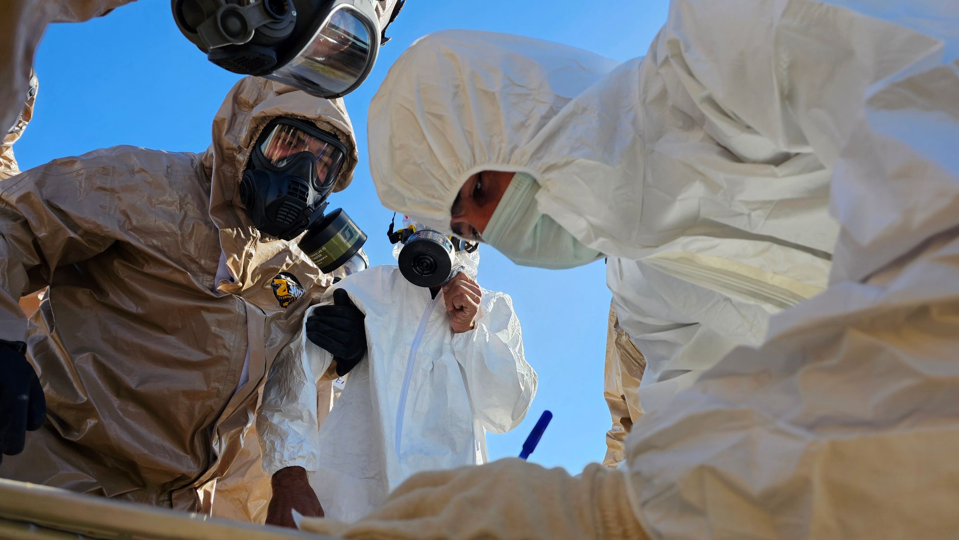 technicians in hazmat suits conducting inspection