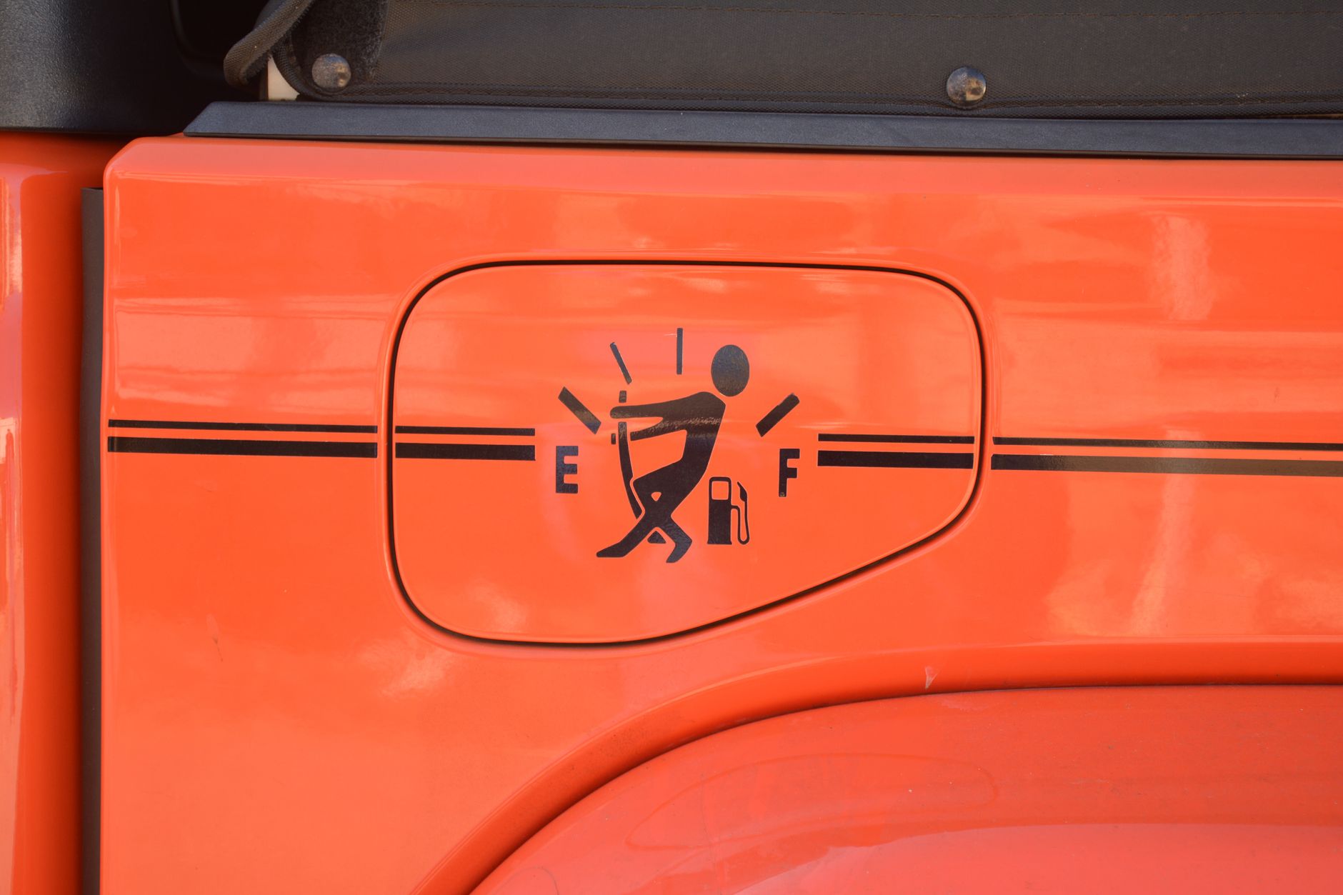 funny fuel gauge sticker on orange jeep door