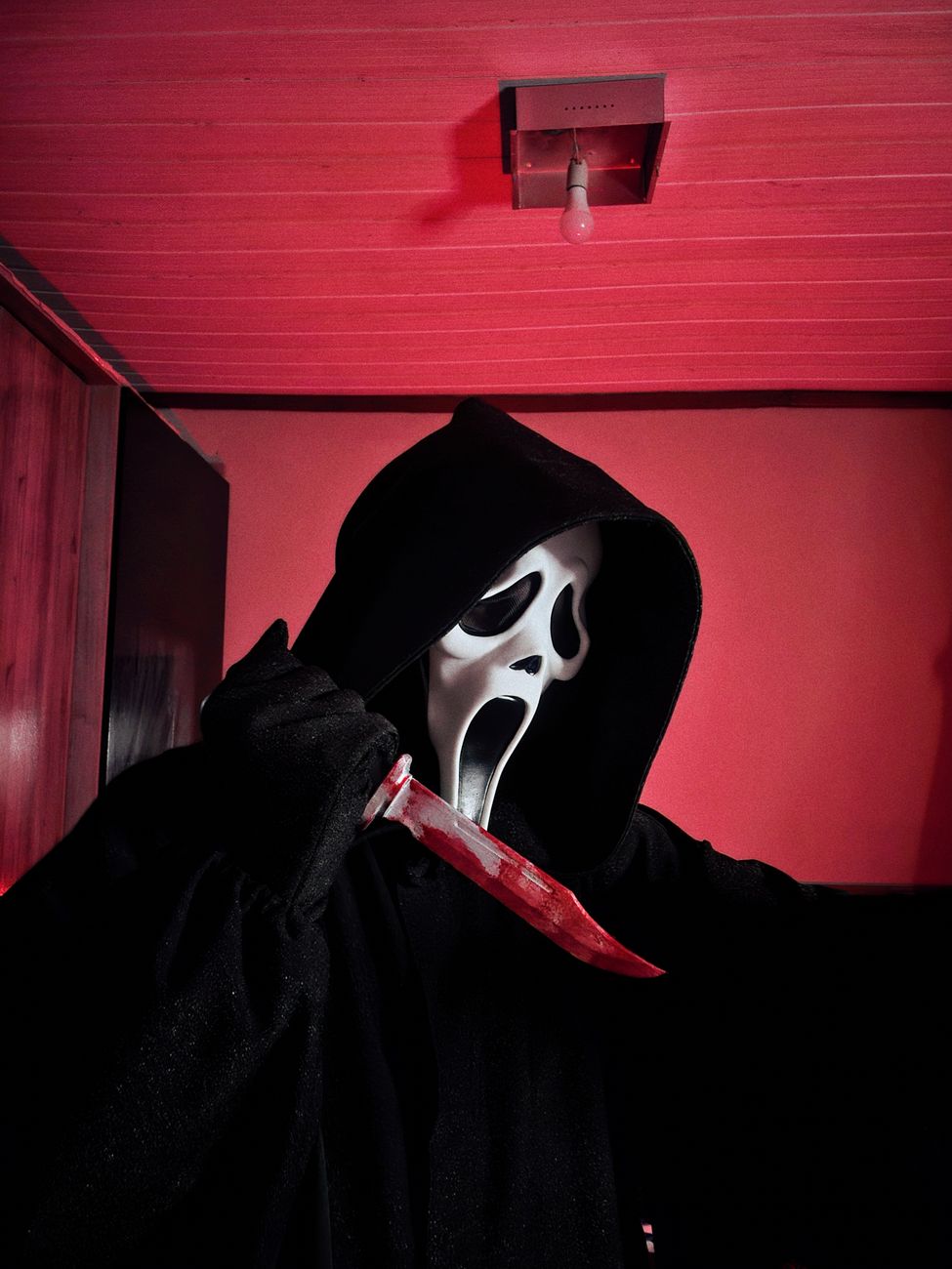 horror figure with knife in red room