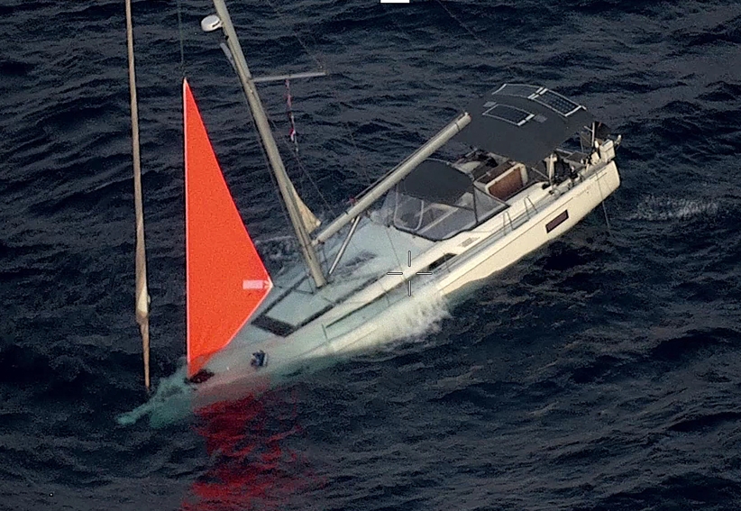 This handout image taken on September 26, 2026 and released by the New Zealand Defence Force on October 1, 2026 shows a yacht sinking after a sperm whale struck and cracked the hull in the remote South Pacific.