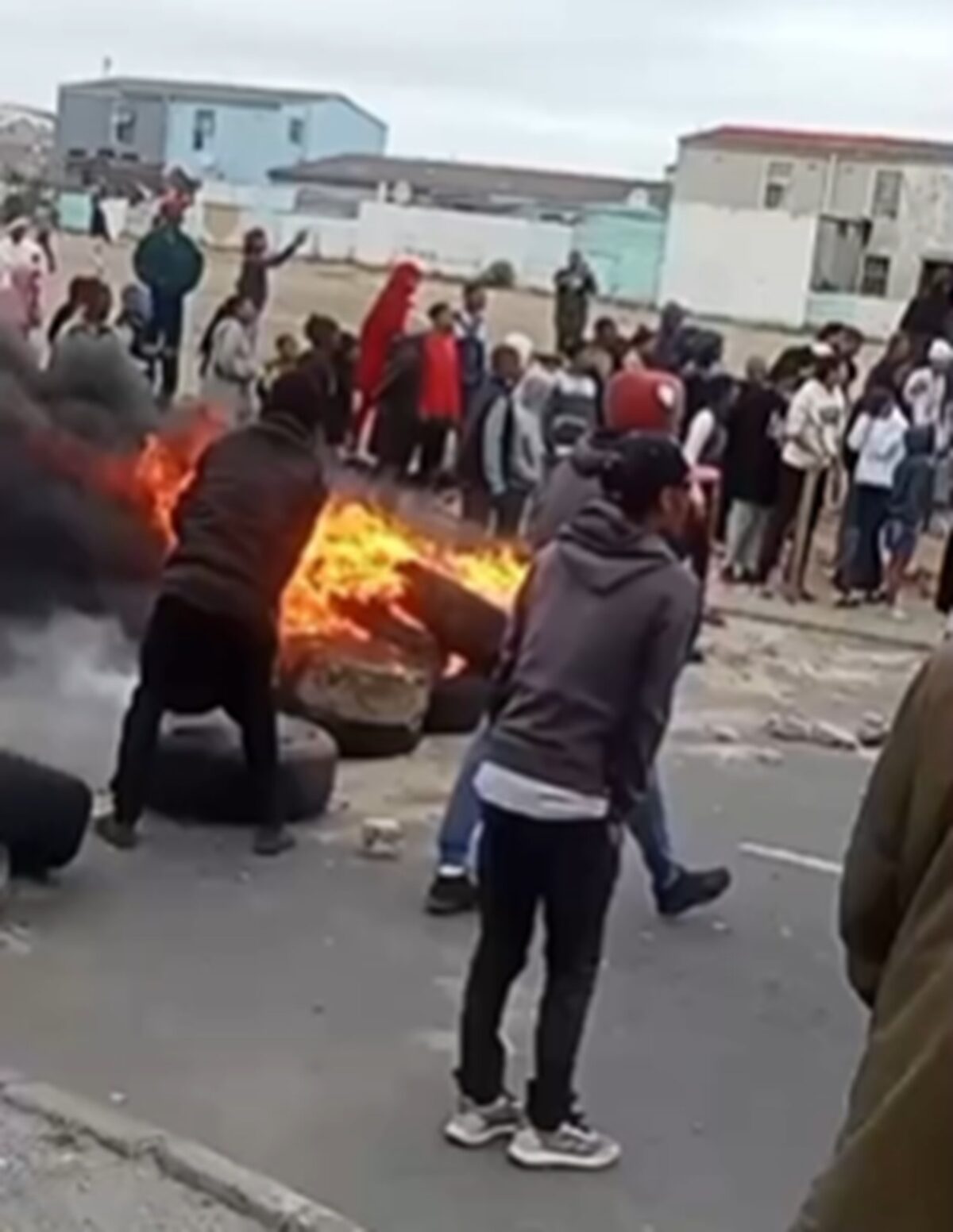 WATCH | Angry mob tries to force murder suspect from his home