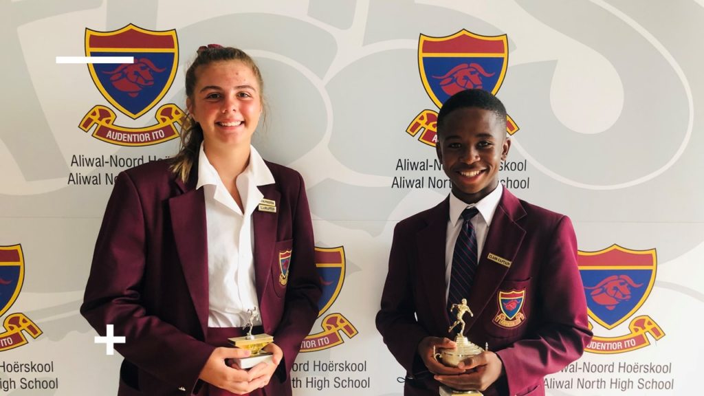 Two athletes with their trophies